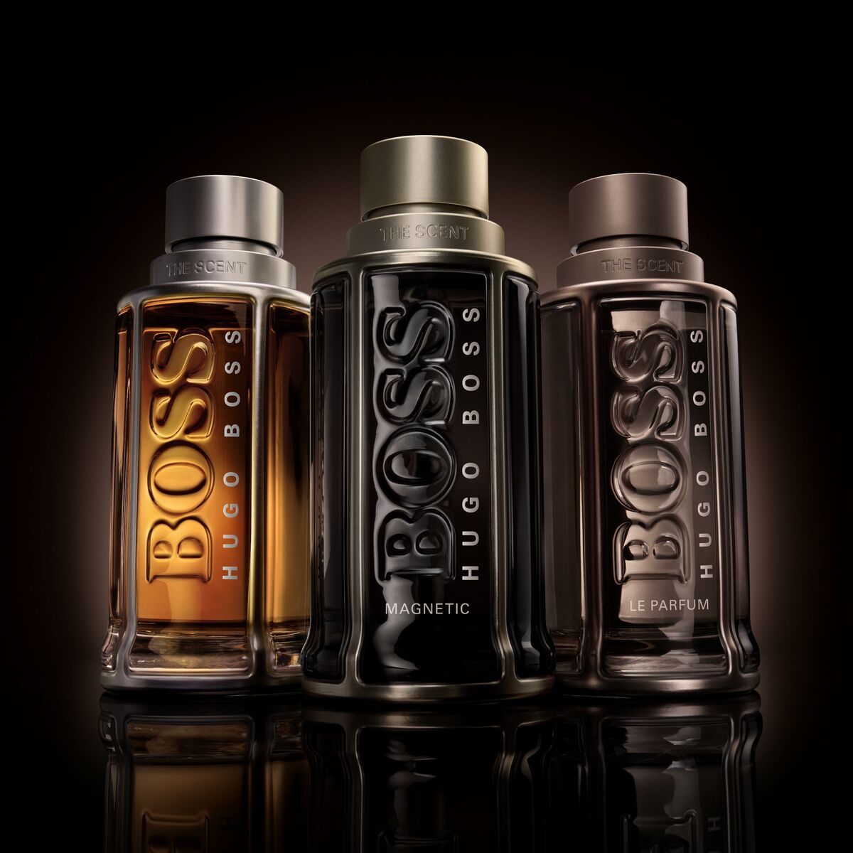 Three Hugo Boss fragrance bottles: THE SCENT, MAGNETIC, and LE PARFUM, showcasing stylish packaging.
